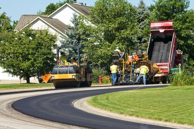 Commercial asphalt paving during summer